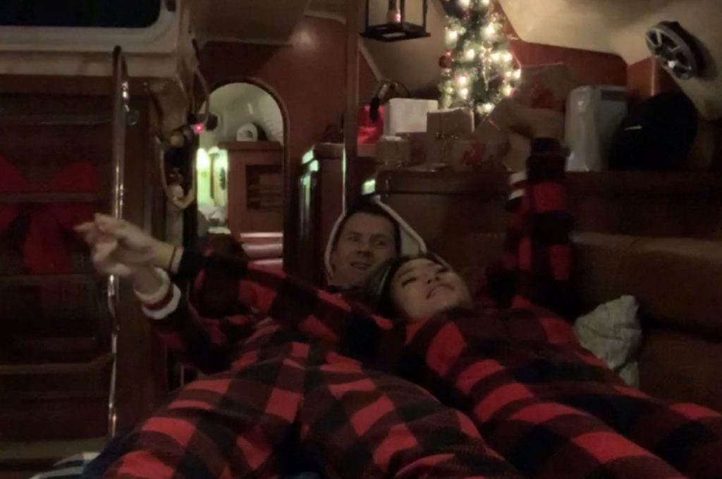 Couple in pyjama inside a boat during winter