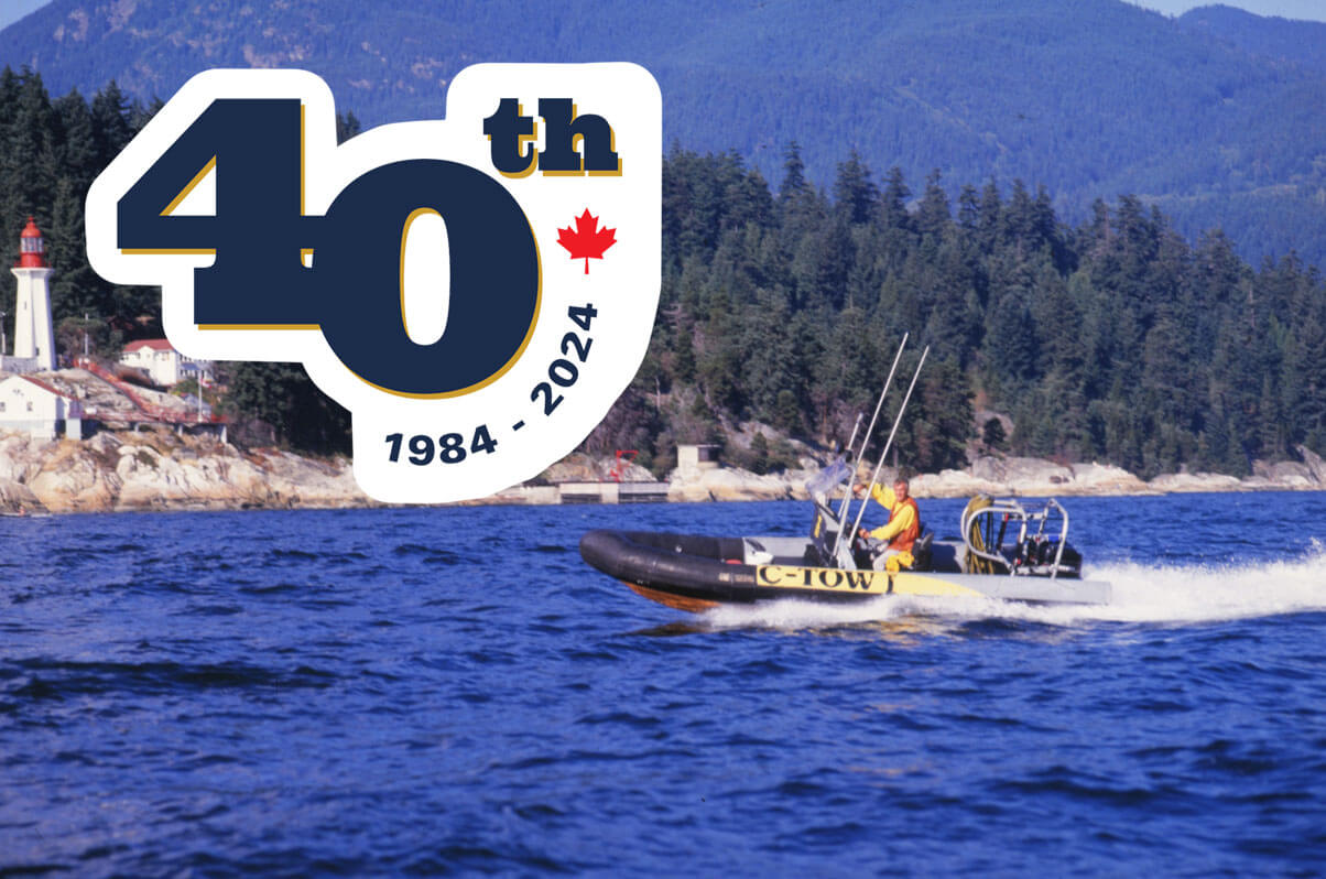 C-Tow co-founder Jim McDonald pictured waving from his C-Tow Zodiac off Point Atkinson in 1985. Credit Sea Snaps